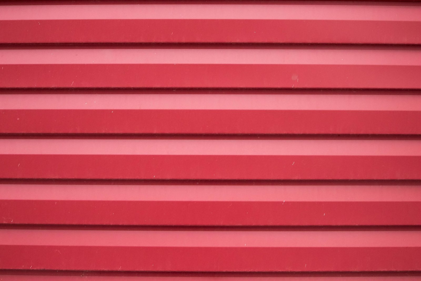 Close-up shot of a red corrugated metal surface providing a textured background.