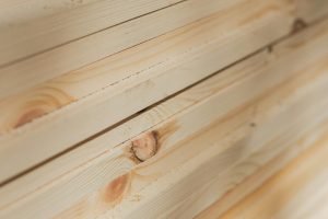 Close-up view of neatly stacked wooden planks highlighting their natural texture and grain.